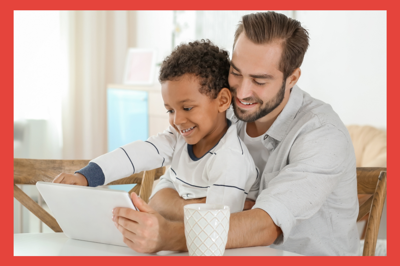 Dad and son playing on ipad. 